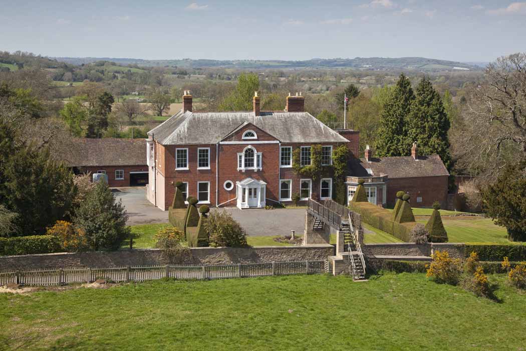 Arrive by helicopter and walk over the bridge to the house